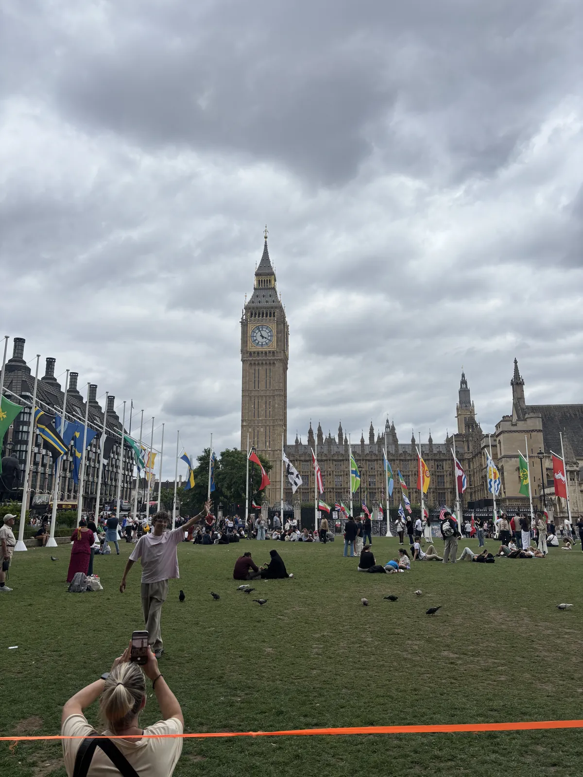 Big Ben and Parliament Square with international flags on a summer day